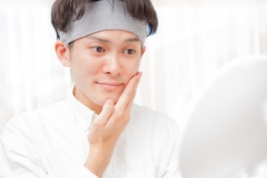 鏡を見ている男性